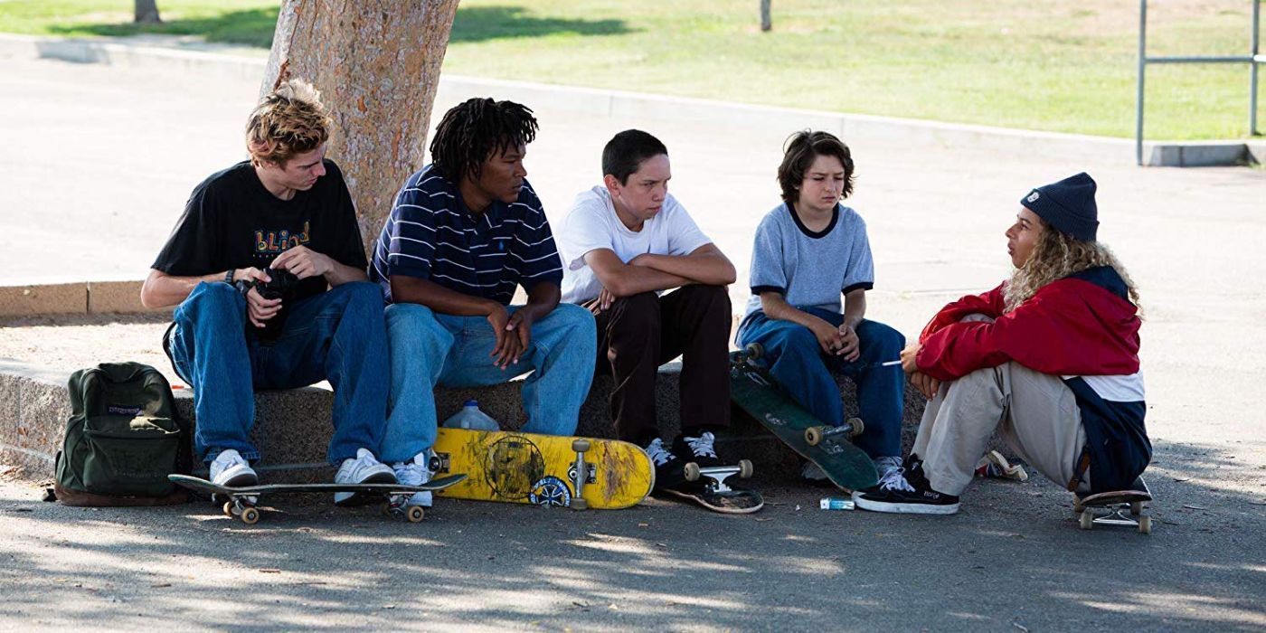 Mid90s skate group sitting on the curb