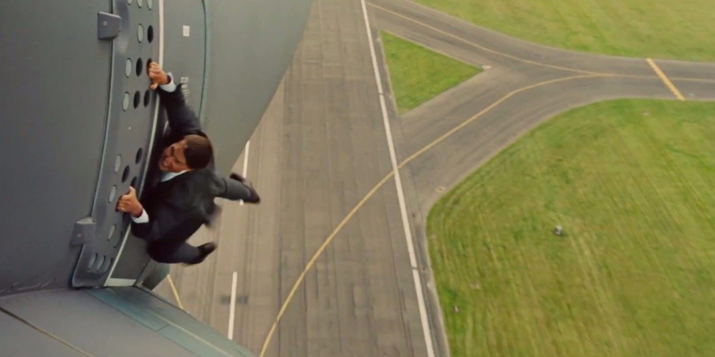 Ethan Hunt hanging from a movin plane in M:I - Rogue Nation