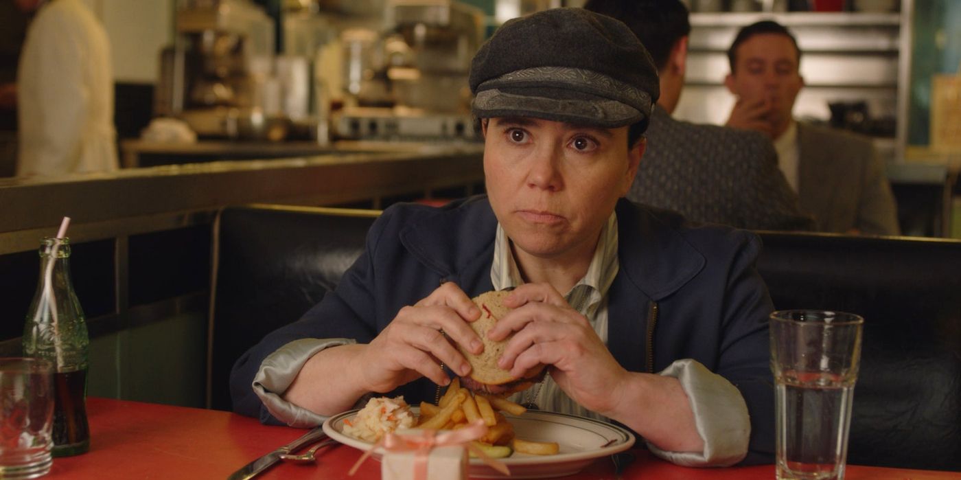 Susie eating a burger in The Marvelous Mrs. Maisel