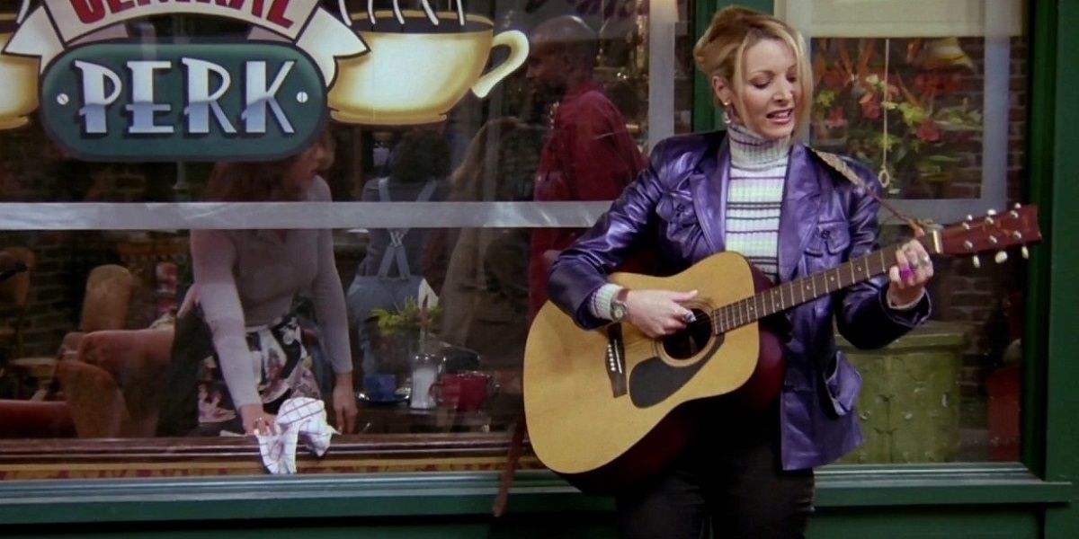 Phoebe on Friends playing her guitar outside of Central Perk
