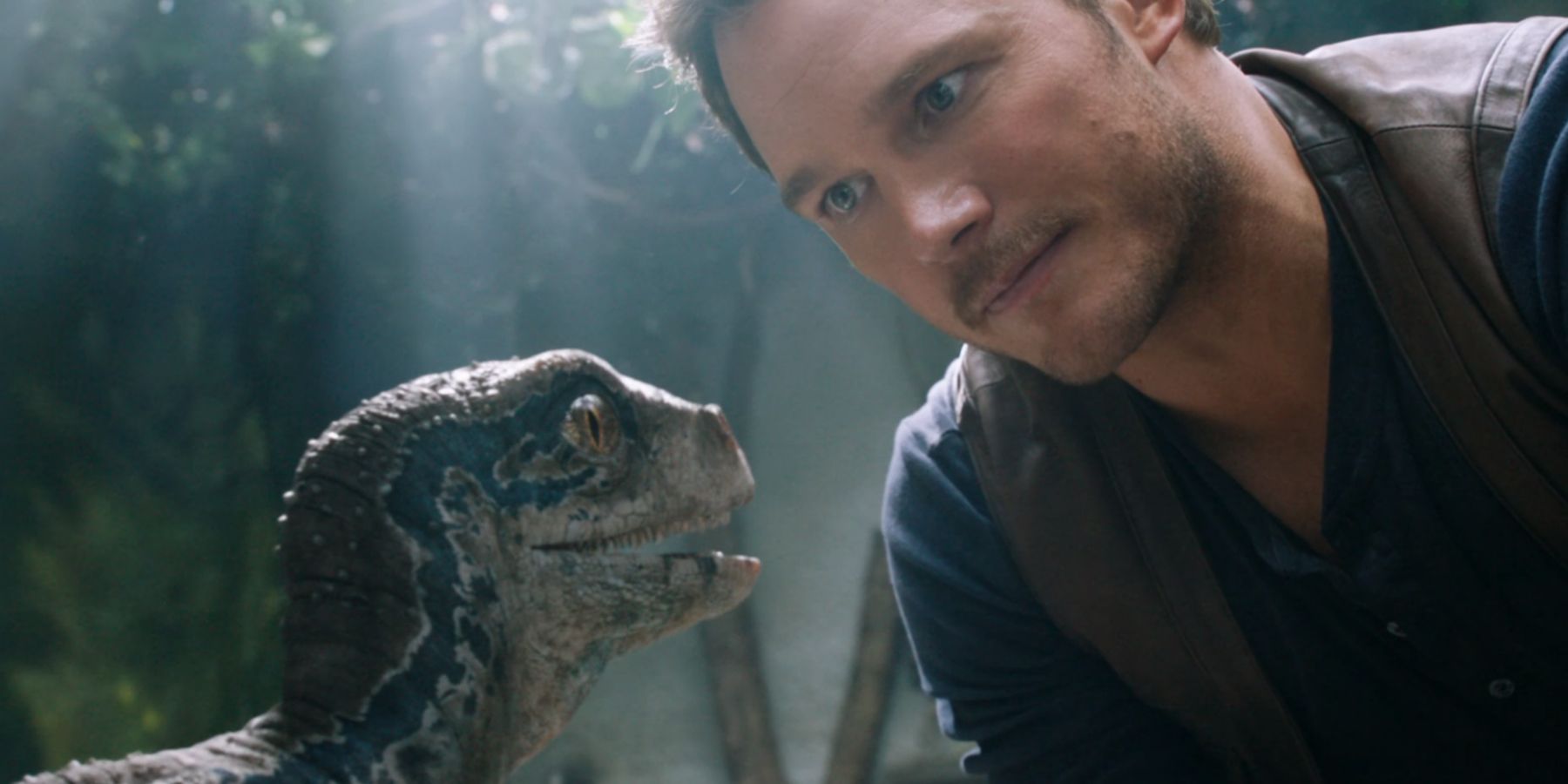 Owen Grady bonding with a baby Blue in Jurassic World Fallen Kingdom