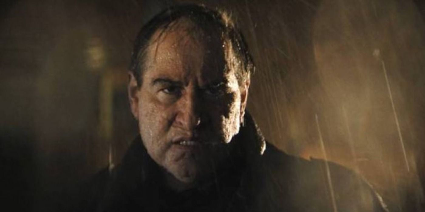Colin Farrell's grimacing Penguin under the rain in The Batman