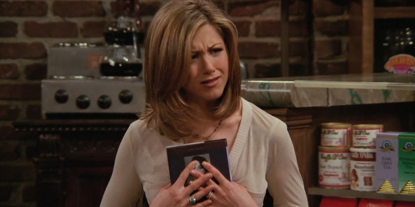 Rachel Green holding a book at Central Perk in Friends