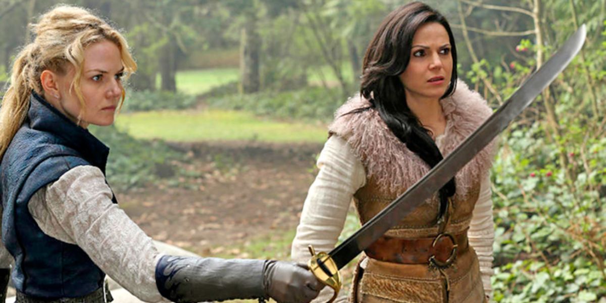 Regina standing next to Emma who's holding up a sword in Once Upon A Time