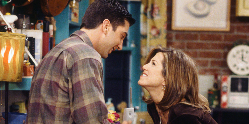 Ross and Rachel laughing in a scene in Friends. 