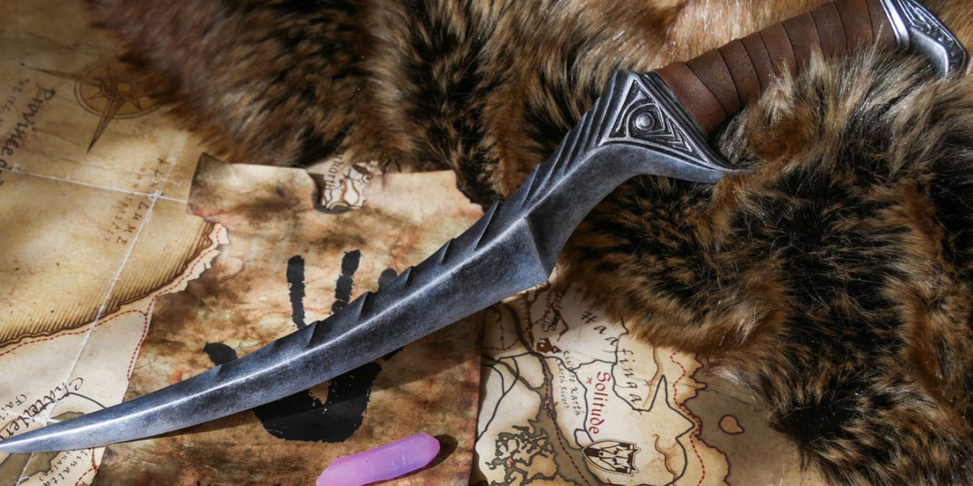 Blade of Woe dagger on Dark Brotherhood paper, a fur, and Skyrim map