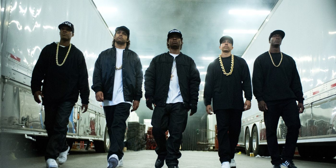 Rap group NWA from Straight Out of Compton walking by trucks