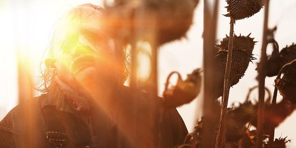 Leatherface looks sad in the sunflowers in Texas Chainsaw Massacre 2022