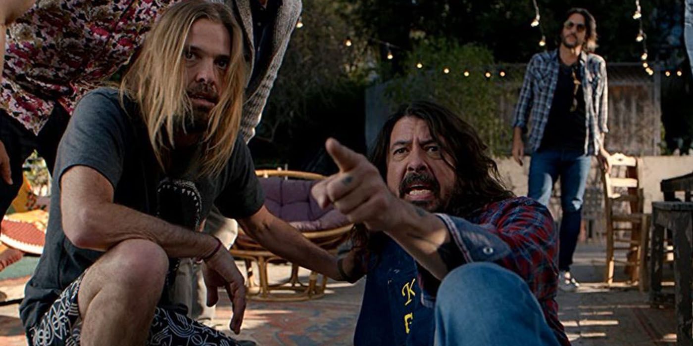 Taylor with Dave Grohl lying on the ground.