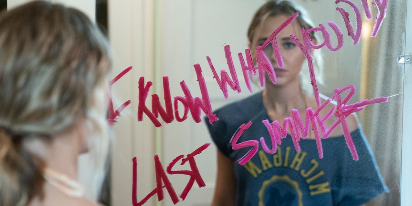 Character looking in mirror with lipstick writing the title of the show 