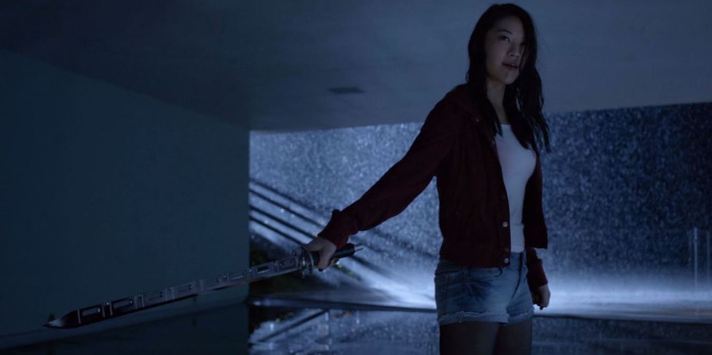Kira stands in the rain with her sword in Teen Wolf