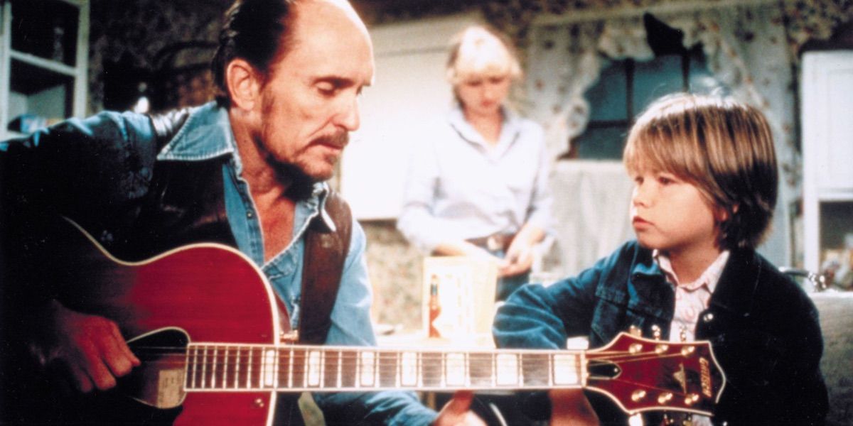 Robert Duval plays guitar while a child listens from Tender Mercies 