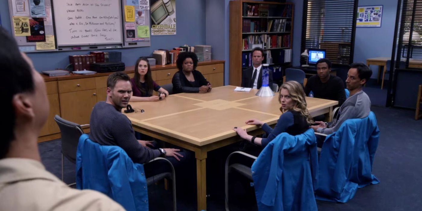 The Community cast sitting around a table.