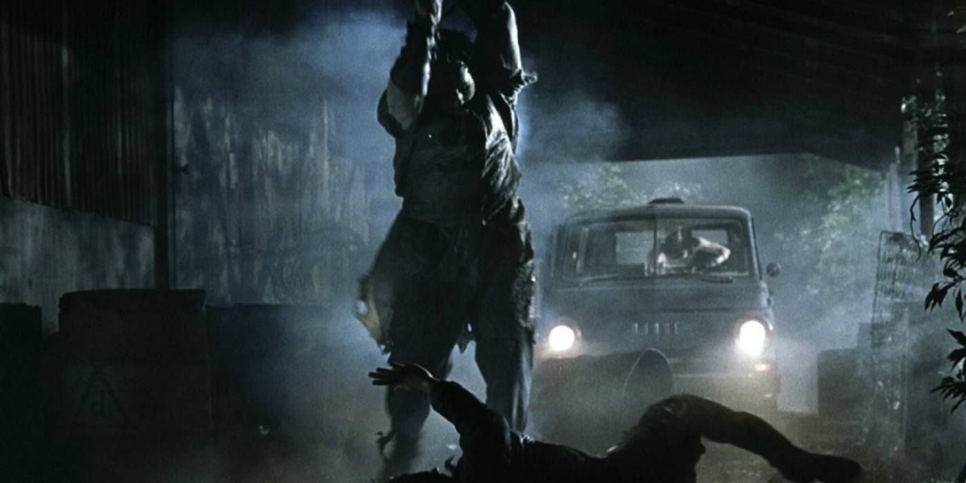 Leatherface raising a chainsaw above a victim's head in The Texas Chainsaw Massacre 2003