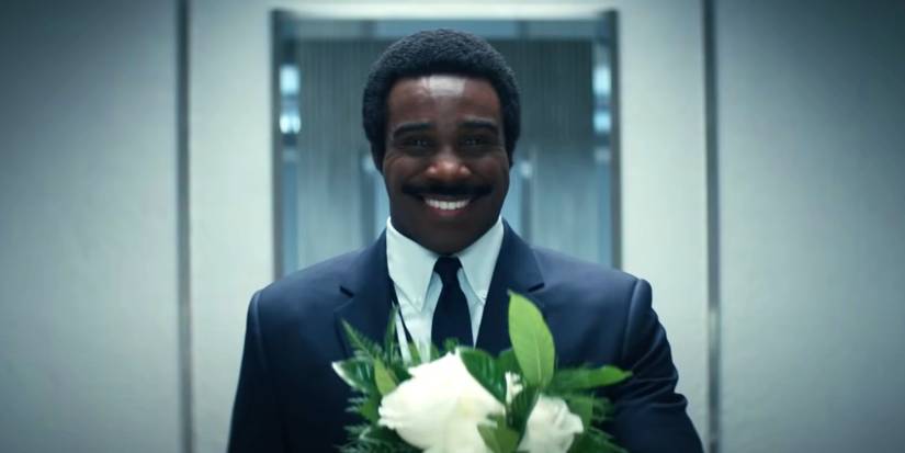 Mr. Milchick holding a bouquet in Severance