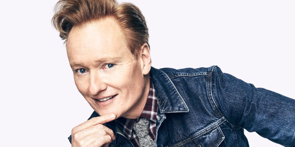 Conan O'brien poses in front of a white background 