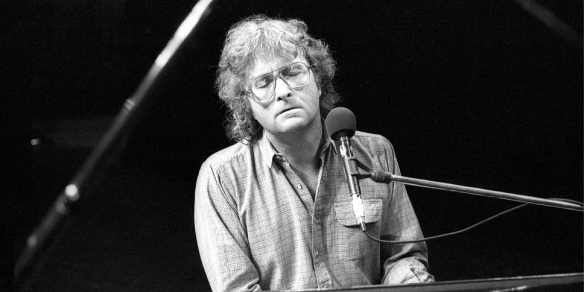 Randy Newman plays the piano and sings 