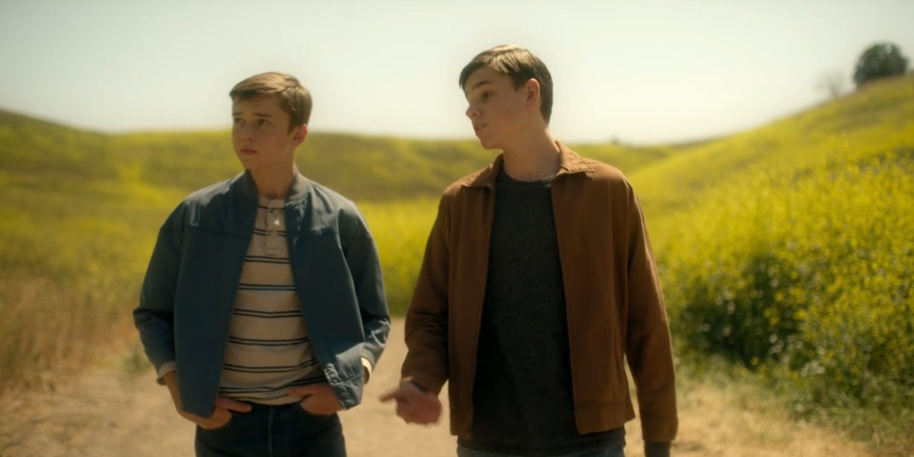 Young Jack and Joe walk in Reacher