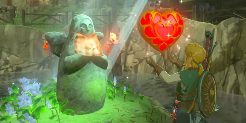 Link standing in front of the Goddess Statue and holding a Heart Container in Breath of the Wild