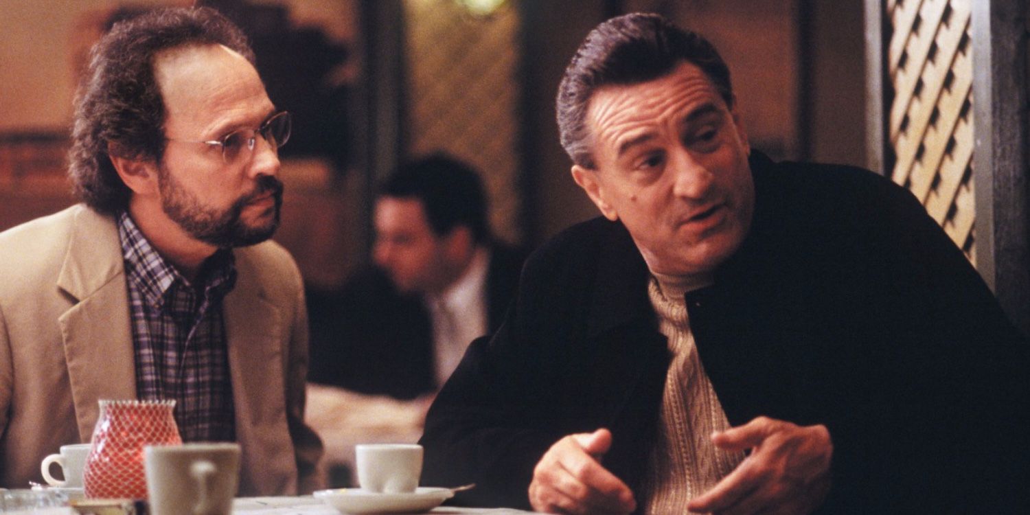 Billy Crystal and Robert De Niro sitting on a dining table in Analyze This