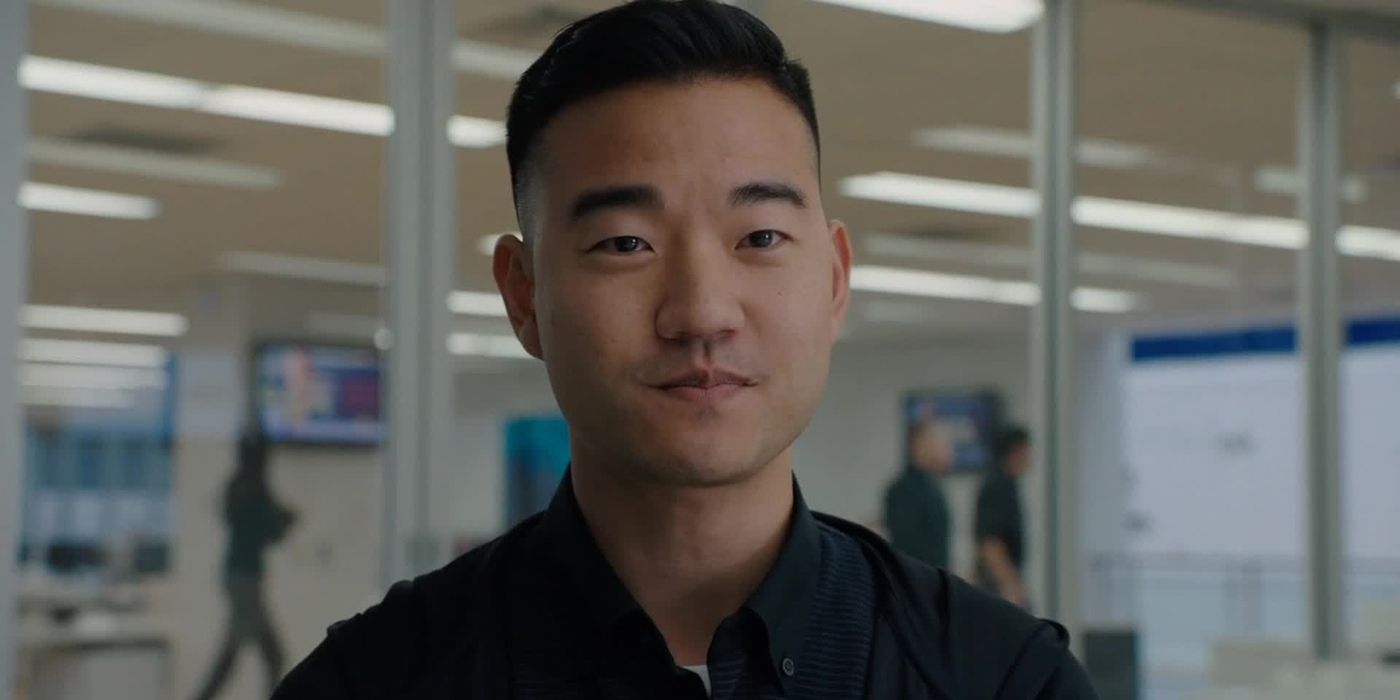 A close up of Ben Kim from Billions smiling.