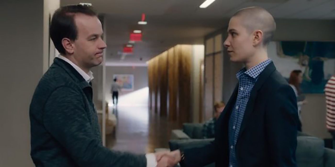 Oscar and Taylor facing one another and shaking hands on Billions.