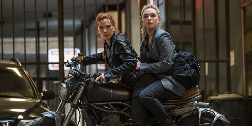 Yelena rides behind Natasha on a motorcycle in Black Widow