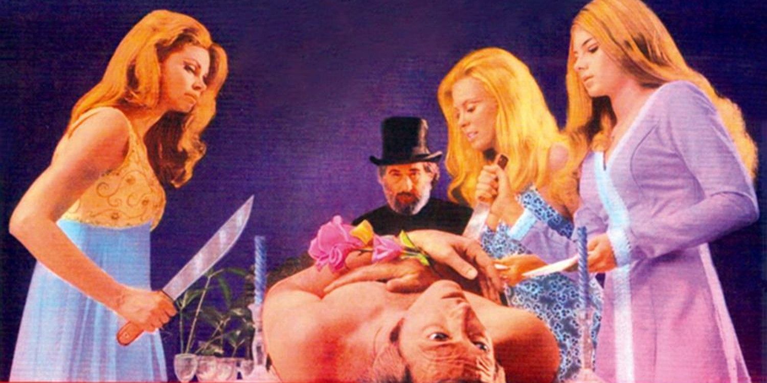 The women of Cannibal Girls with a knife, standing over a captive man