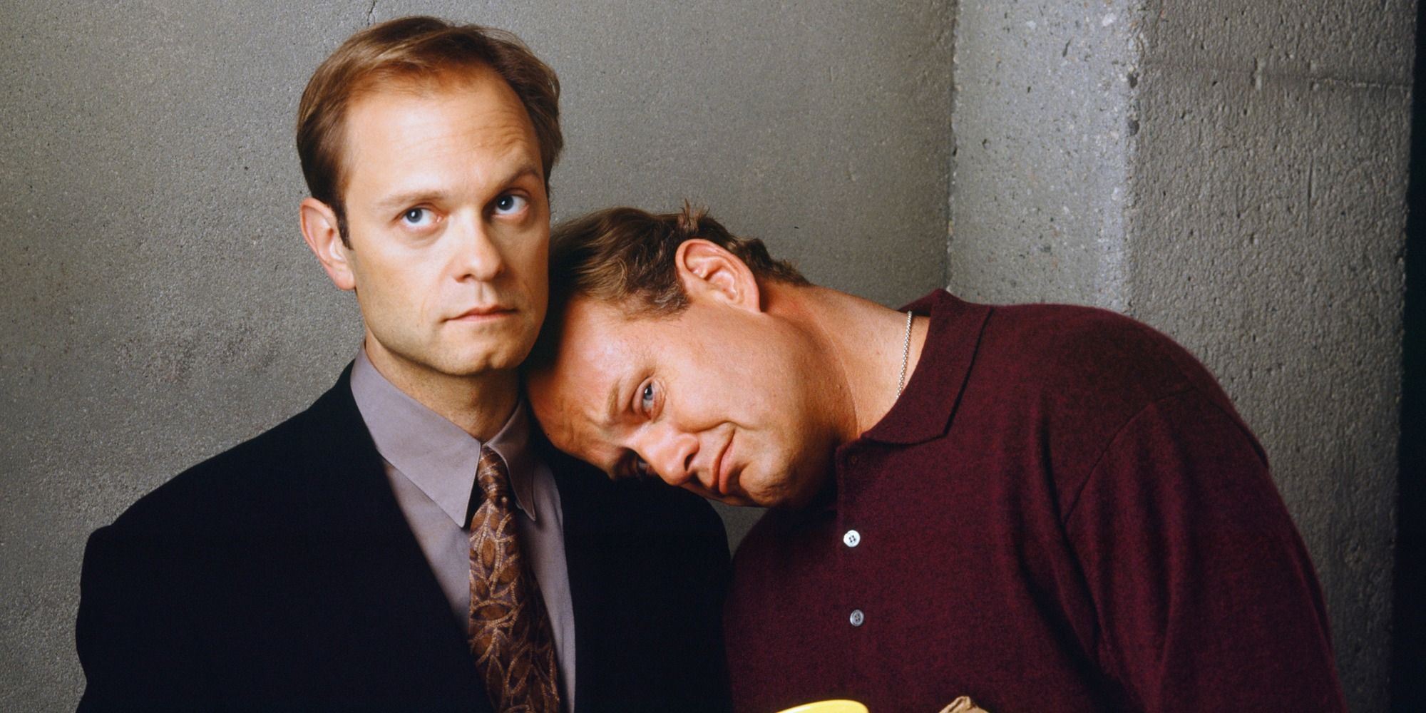 Frasier leaning on Niles' shoulder in a promo image for Frasier