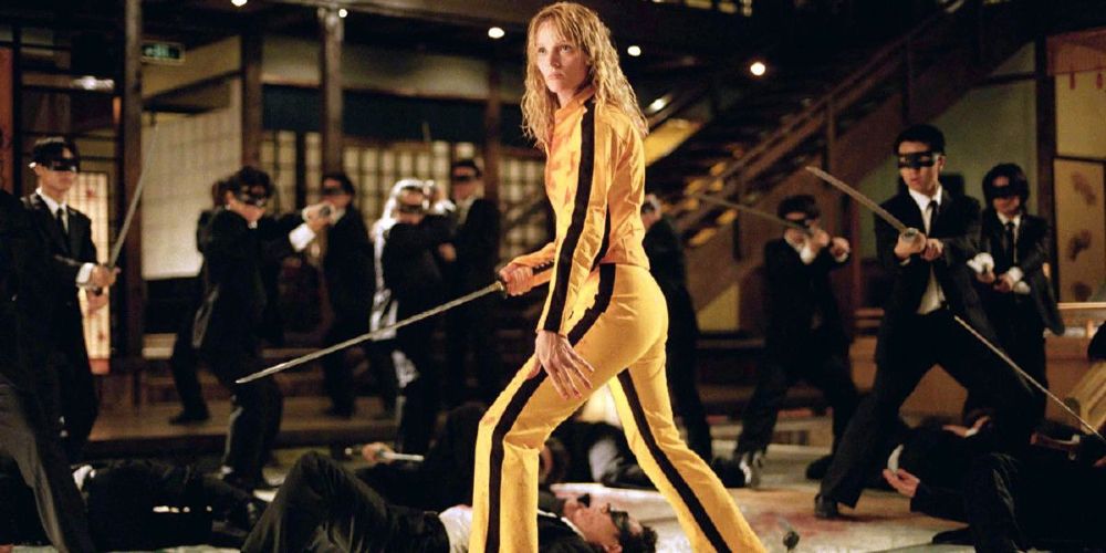 The Bride holds a sword and wears a yellow suit in Kill Bill