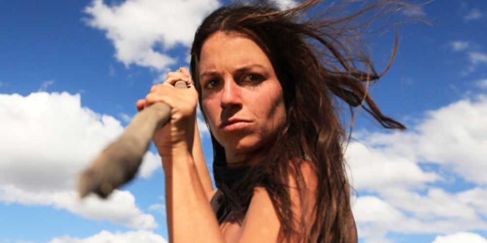 Laura jousts a spear at the camera on Naked and Afraid