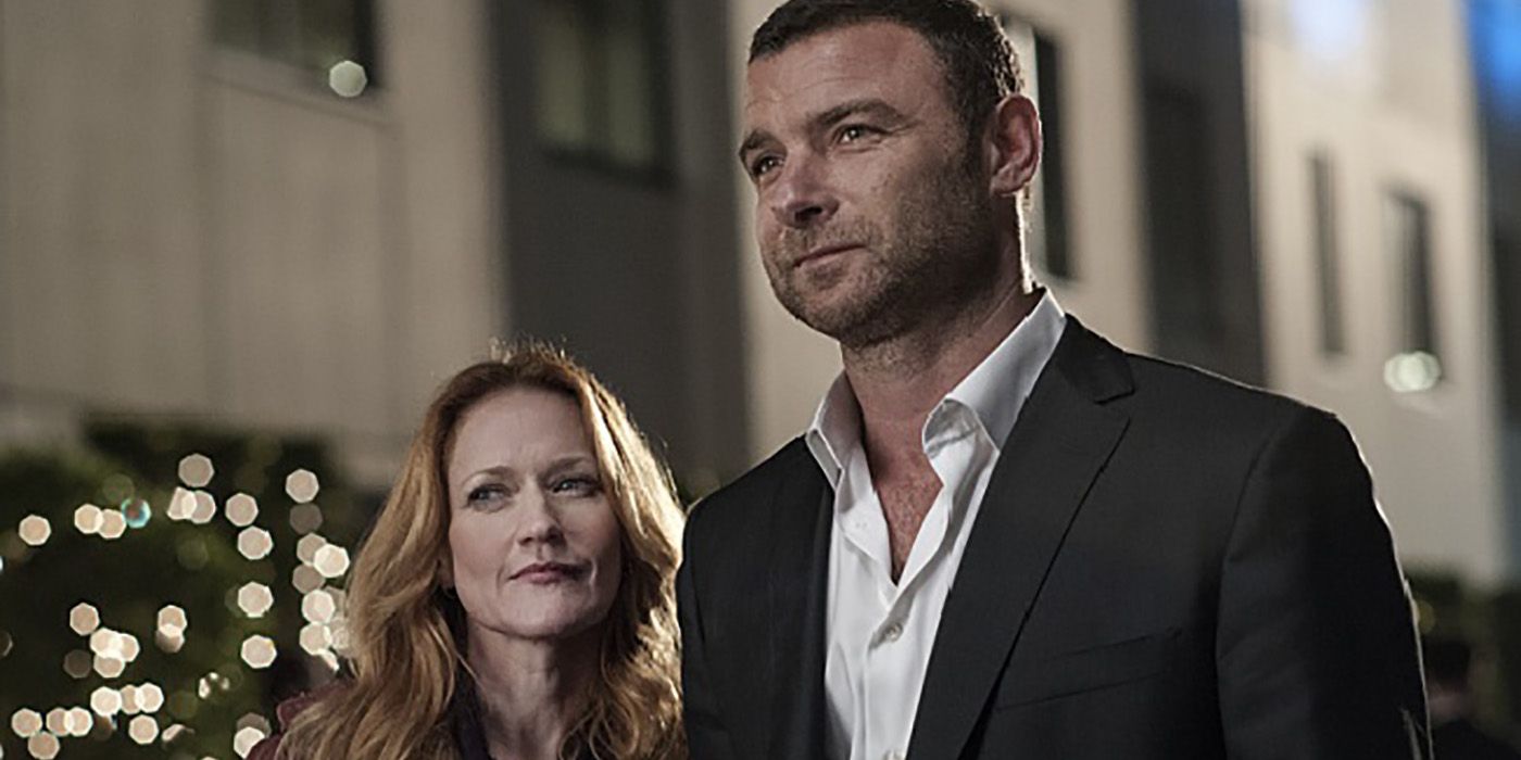 Ray and Abby from Ray Donovan, standing together, smiling.