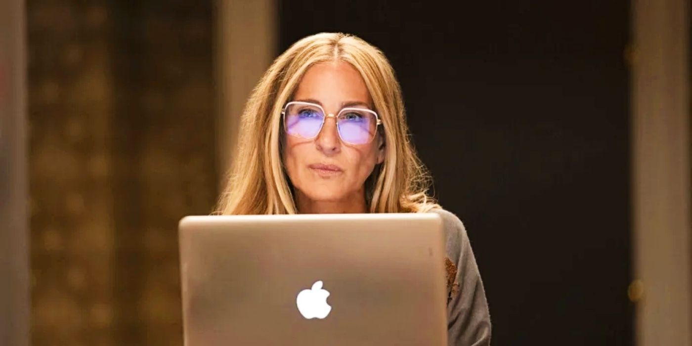 Carrie (Sarah Jessica Parker) sitting with a computer in And Just Like That