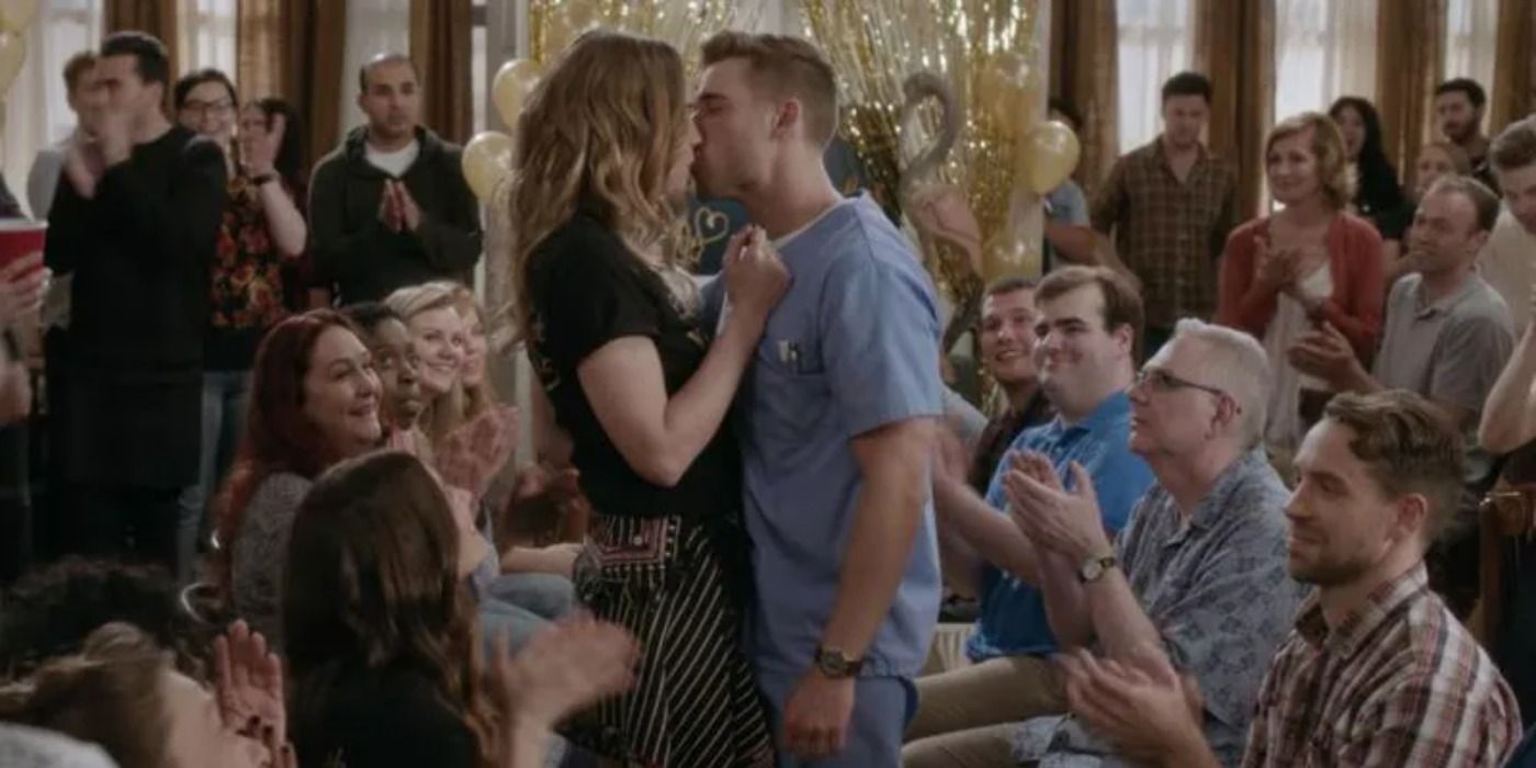Alexis and Ted kissing during Singles Week on Schitt's Creek