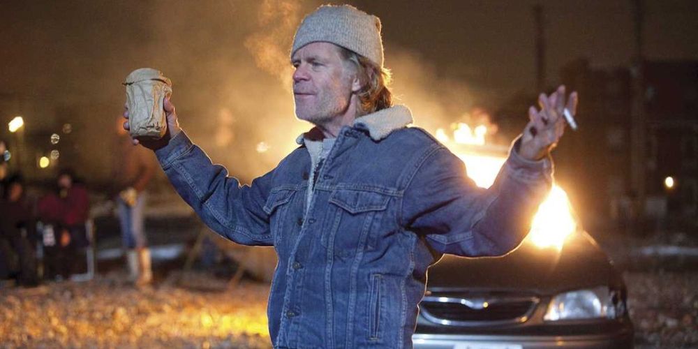 Frank holds a beer and cigarette outside on Shameless