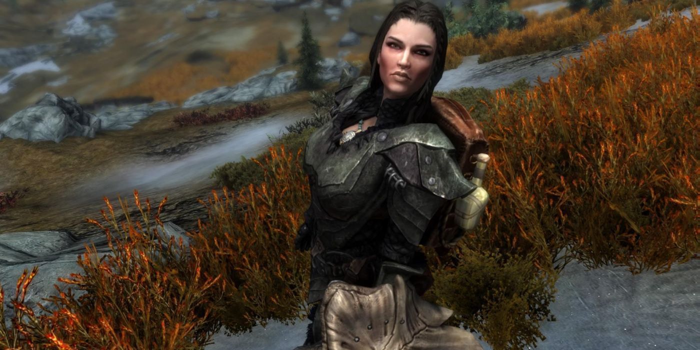Lydia from Skyrim, standing on a grassy slope and looking up at the camera.