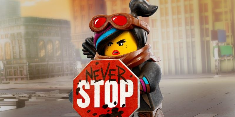 Lucy from The Lego Movie holding a sign that stop sign says 'never stop'