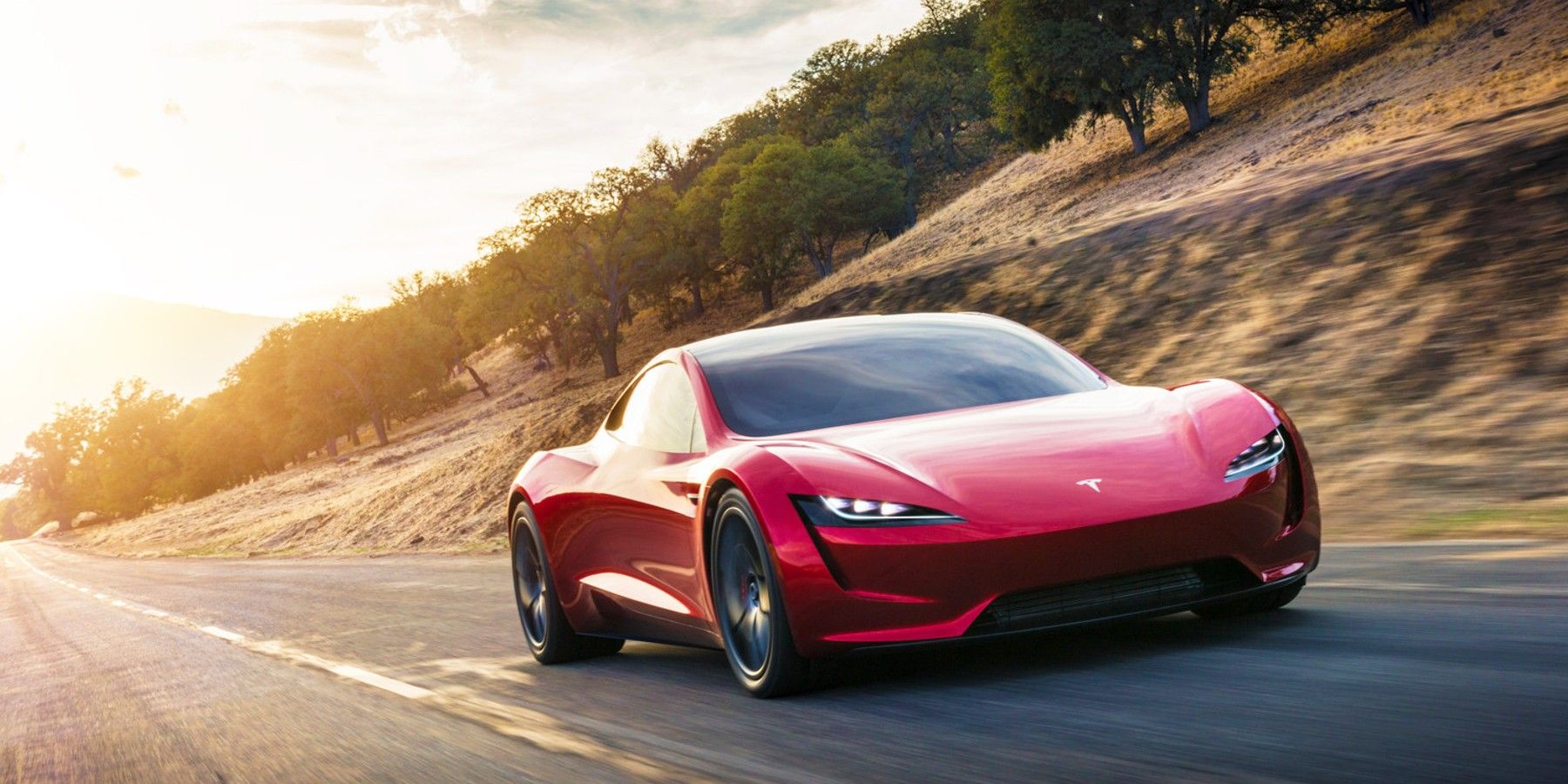 Tesla Roadster speeding down the road.