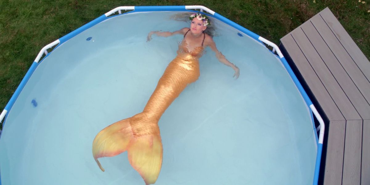 Image of a mermaid relaxing in a large pool