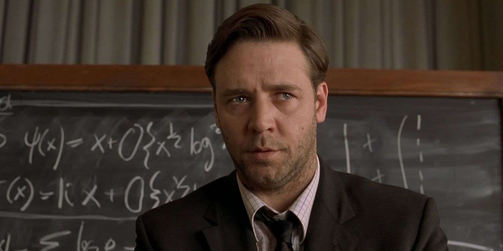 Russell Crowe has a five o'clock shadow and a thousand-yard stare in front of a math blackboard in A Beautiful Mind.