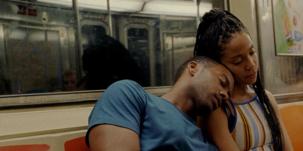 A man and woman lean on each other in a subway train in Premature 