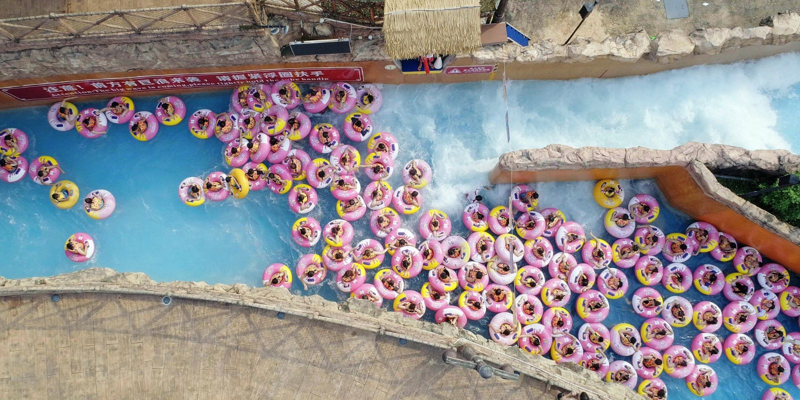 A still from Ascension featuring several people in inflatable tubes in a pool