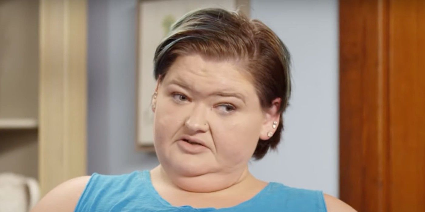 Amy Slaton in 1000-lb Sisters looking serious in blue top and short hair