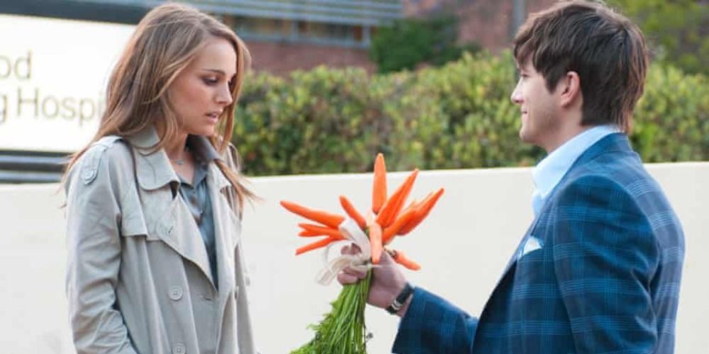 An image of Ashton Kutcher handing some carrots to Natalie Portman