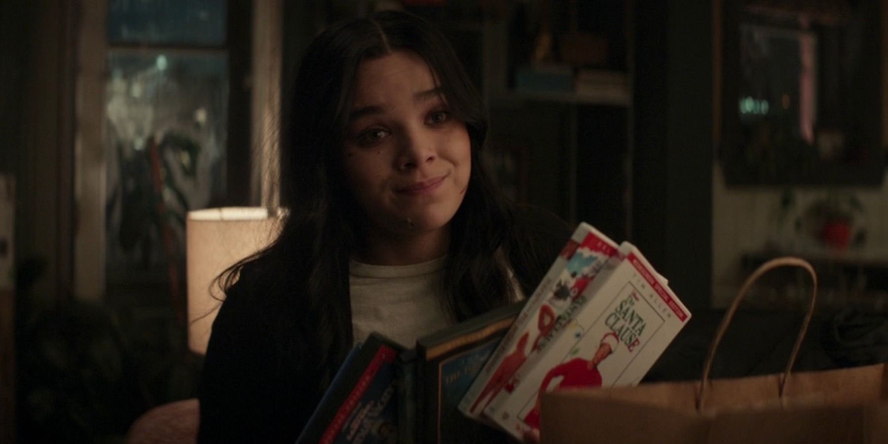 An image of Kate holding several DVDs in Hawkeye