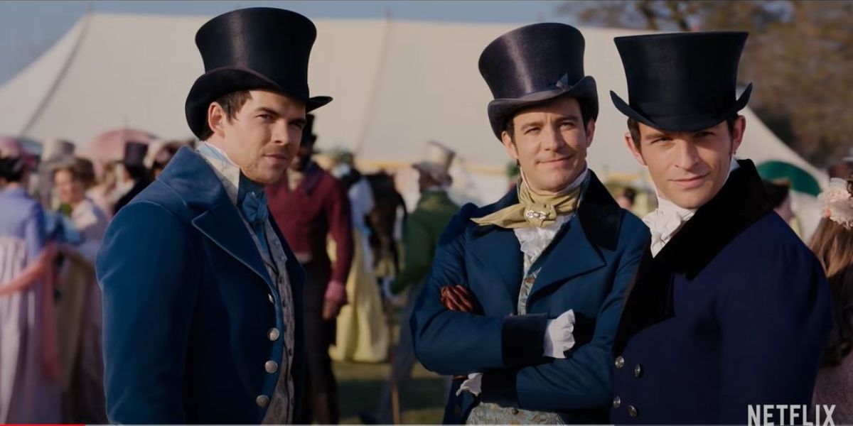 Anthony, Colin, and Benedict standing together wearing top hats at the horse race in Bridgerton season 2