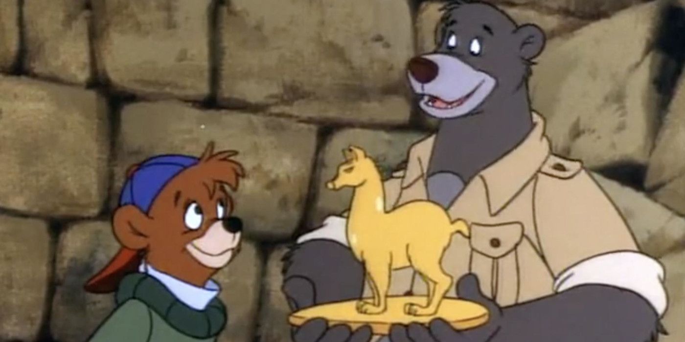 Baloo and Kit holding a gold statue in TailSpin