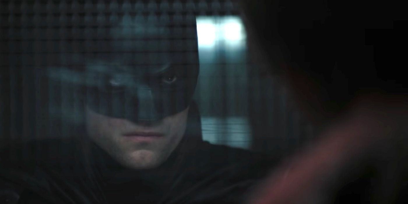 Batman glaring at the Riddler through the bullet-proof glass