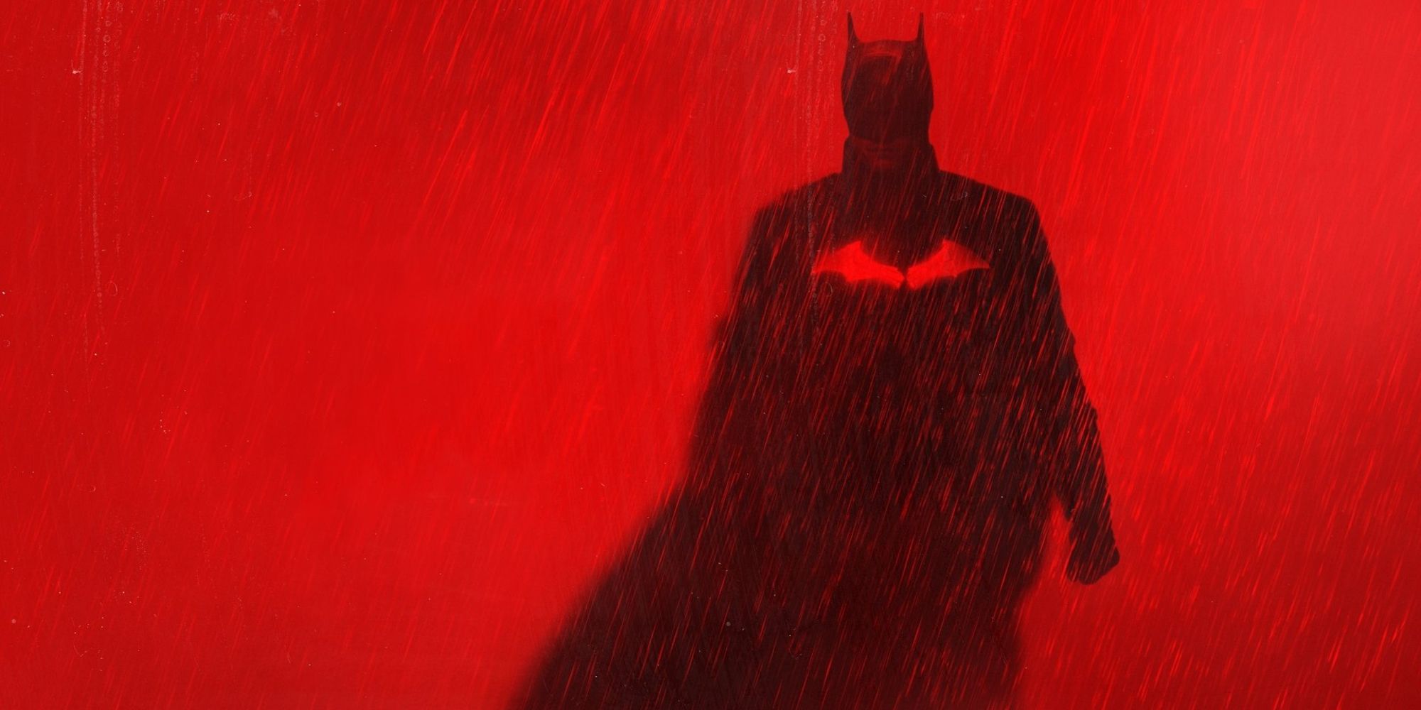Batman standing in the rain in official banner for The Batman 2022