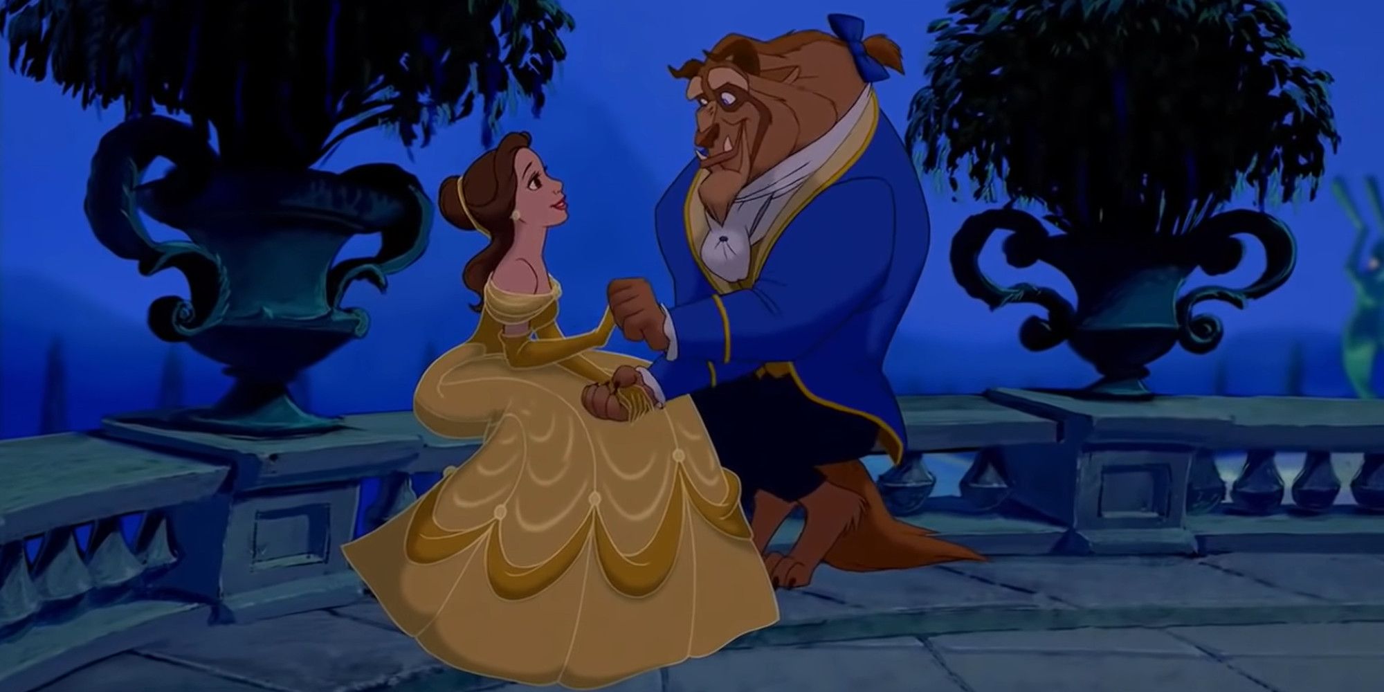 Belle and the Beast sit outside the castle in Beauty and the Beast